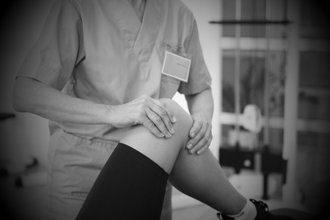 medical-assistant-helping-patient-with-physiotherapy-exercises